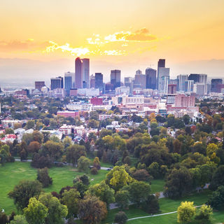 Denver Colorado skyline backed by mountains.